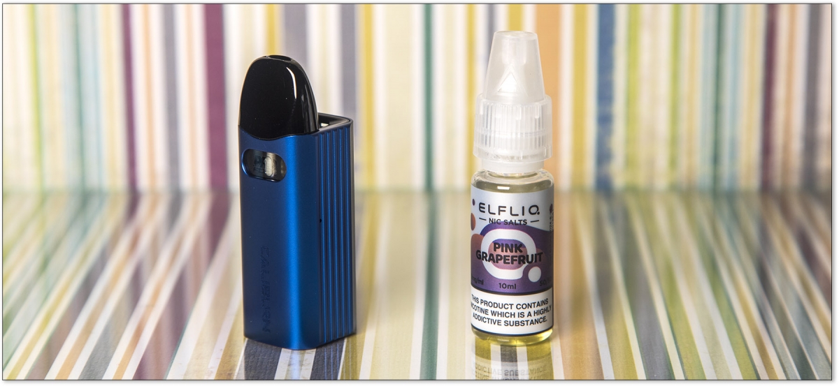 Uwell Caliburn AZ3 Pod Kit next to an e-liquid bottle